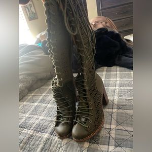Green, laced up knee high boots
